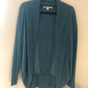 Gypsies and moon dust brand cardigan with lace detail on the back in a size M.